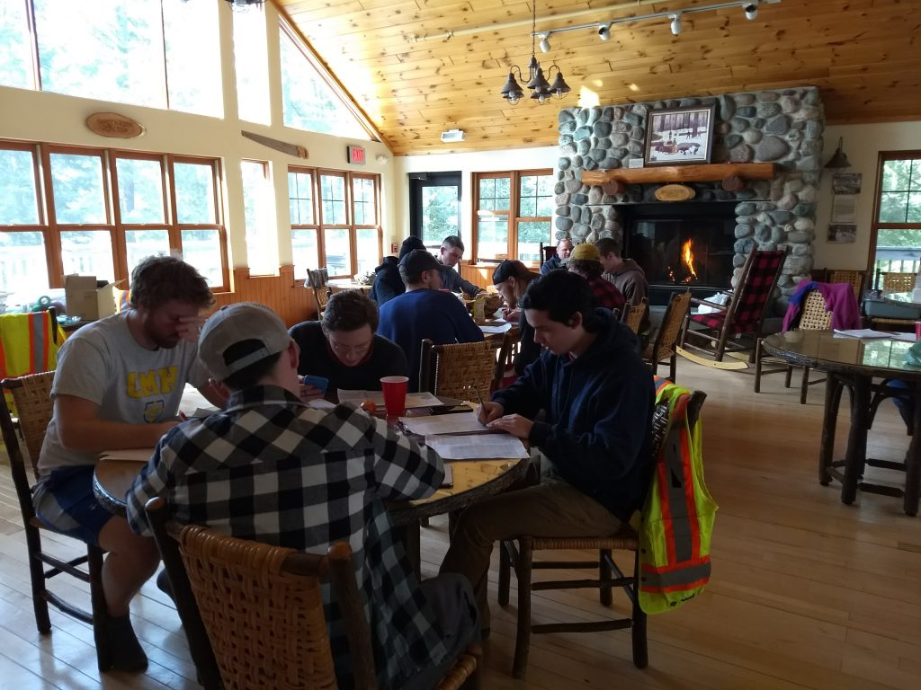 people at table in front of fireplace