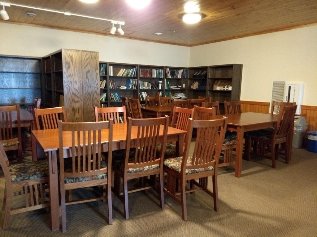 table with chairs, bookcases with books